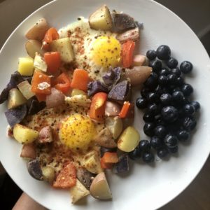 Photo of the egg potato and pepper sheet pan breakfast bake on a white plate